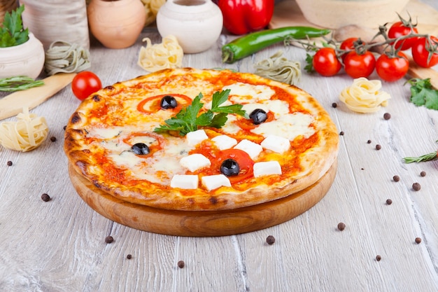 Photo italian pizza on a wooden background with decoration around