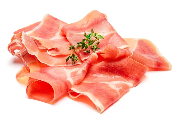 Italian prosciutto crudo or spanish jamon. Raw ham on white surface