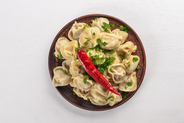 Italian ravioli in the plate on the dark background