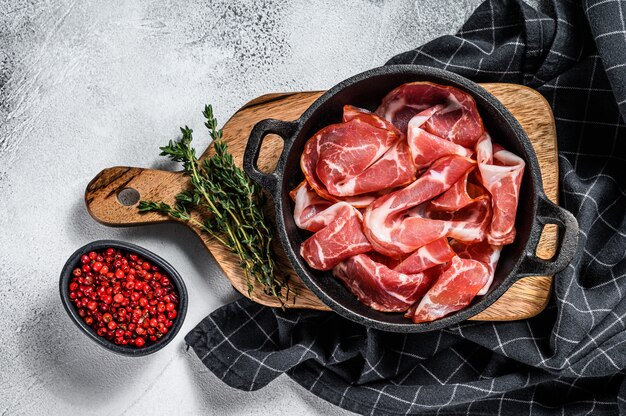 Italian rolled bacon Pancetta Piacentina. Pork meat. White background.