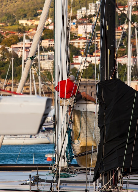  Italian sailor working on tree of sailboat 