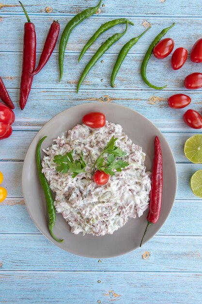 Italian salad on blue wooden background