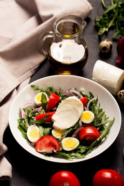 Italian salad prepared with arugula, mozzarella, eggs. Close up shot