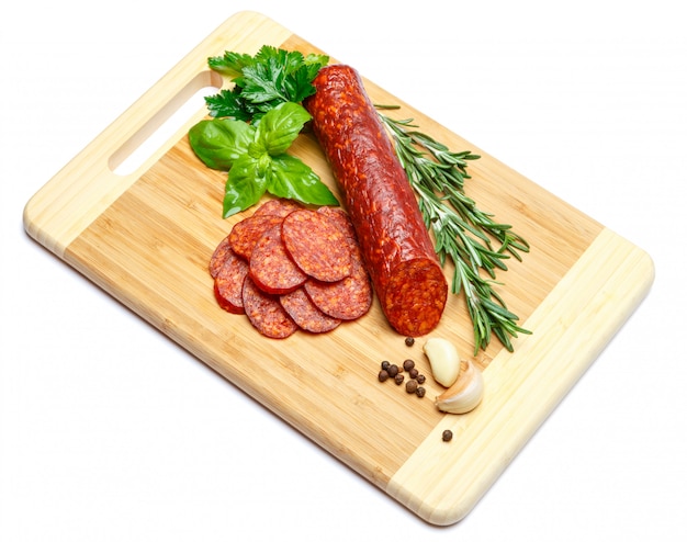 Italian Salami or spanish chorizo on wooden cutting board