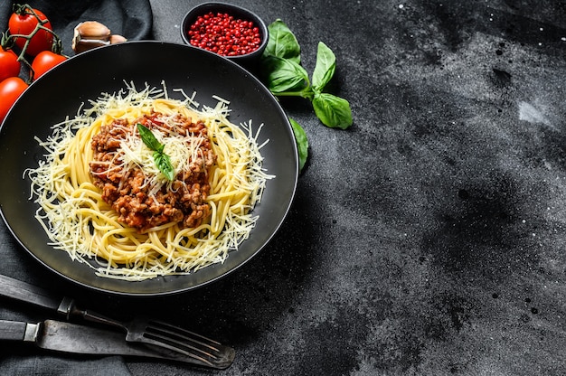 Italian spaghetti pasta with tomato sauce, cheese parmesan and basil