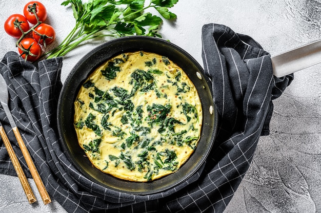 Italian Spinach and Cheese Omelet.  Gray surface. Top view