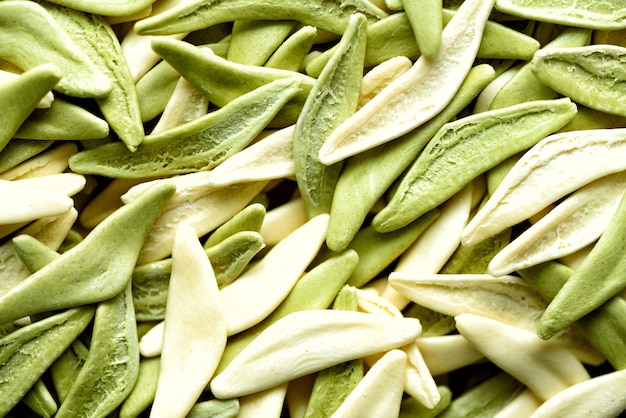 Italian spinach pasta macaroni background texture Top view