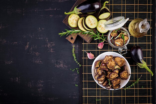 Italian sundried eggplant on a dark table Preserved food Italian appetizer Top view