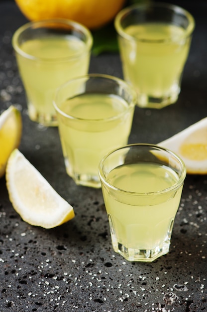 Italian traditional liqueur limoncello with lemon