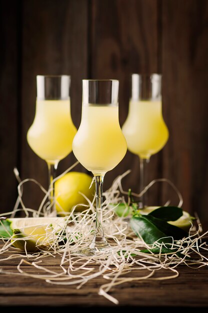 Italian traditional liqueur with lemons on the vintage table