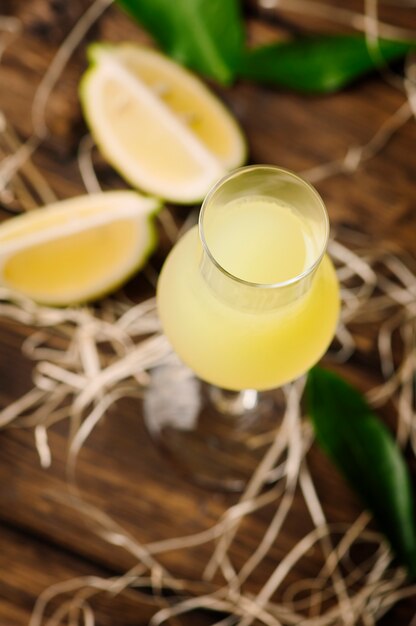 Italian traditional liqueur with lemons on the vintage table