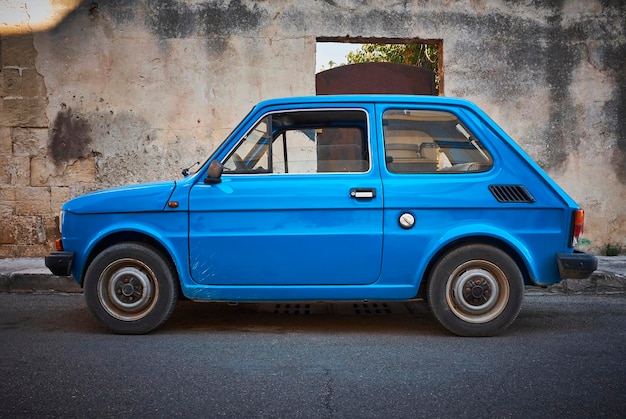 Italy, Apulia, old blue Fiat 500 parked at roadside