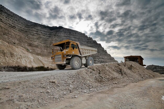 Italy, Maddaloni (Naples), stone pit with industrial vehicles at work