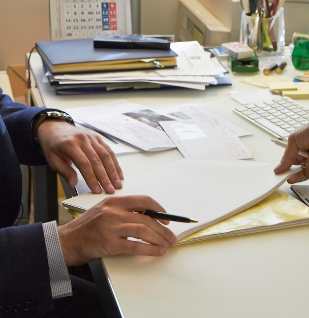 Italy manager hands on his office desk