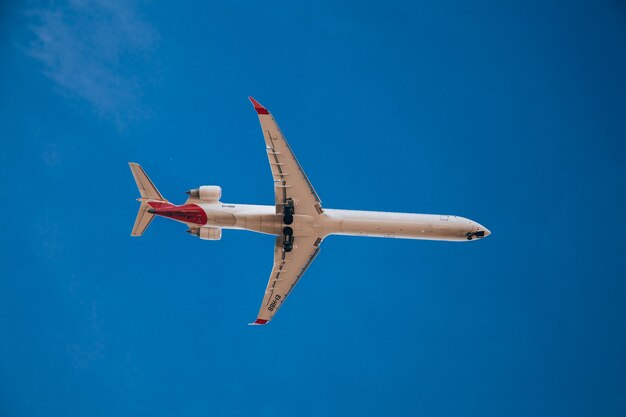 Italy Milan San Donato Milanese 14122023 Low flying plane landing at the airport Linate Airplane against blue sky