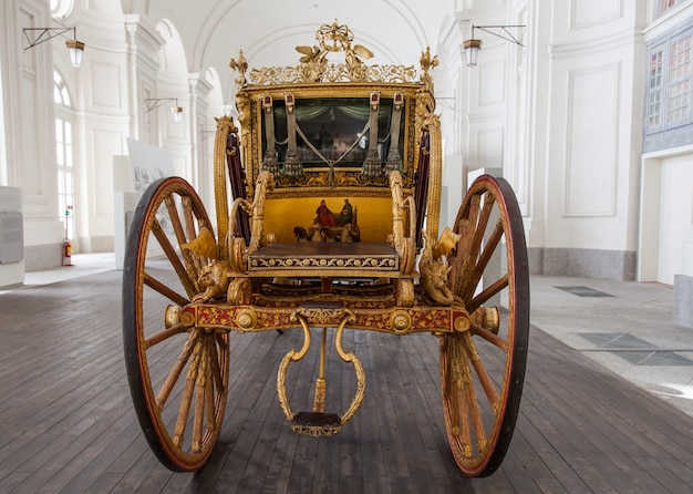 Italy. Old coach on luxury palace background.