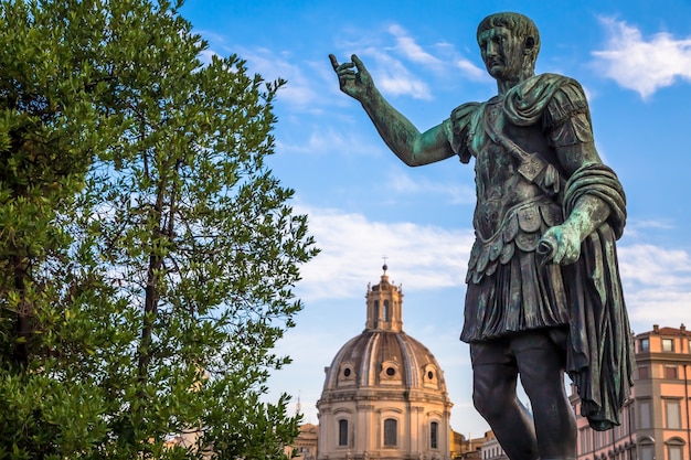 ITALY, ROME - CIRCA AUGUST 2020: Statue of Caesar Emperor, made of bronze. Natural sunrise light. Ancient  role model of Leadeship and Authority .