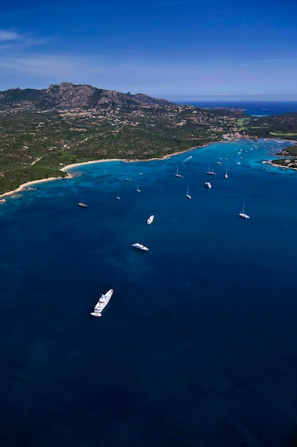 Italy, Sardinia, Olbia province, Emerald Coast, aerial view of luxury yachts in Cala Volpe Bay
