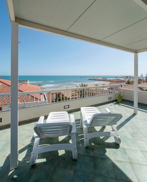 Italy, Sicily, Marina di Ragusa (Ragusa Province); elegant private apartment, view of the terrace with chairs and the sea