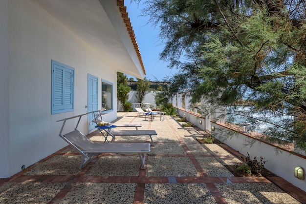 Italy, Sicily, Mediterraean Sea, Torre di Mezzo (Ragusa Province); 18 June 2018, deck chairs in the seafront patio of a private house - EDITORIAL