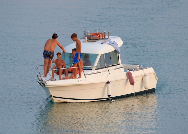 Italy Sicily Mediterranean Sea Marina di Ragusa Ragusa Province 24 August 2023 people on a motor boat in the port EDITORIAL