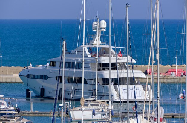 Italy, sicily, mediterranean sea, marina di ragusa (ragusa province); 8 june 2023, view of a big luxury yacht entering in the port - editorial