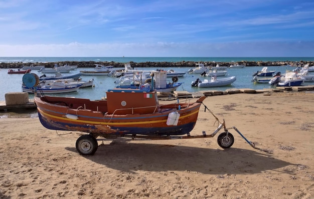 Italy, Sicily, Mediterranean sea, Punta Secca (Ragusa Province); 23 December 2022, view of fishing boats in the port and the beach - EDITORIAL