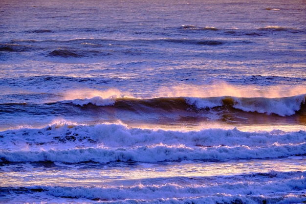 Italy, Sicily, Mediterranean sea, rough sea waves at sunset