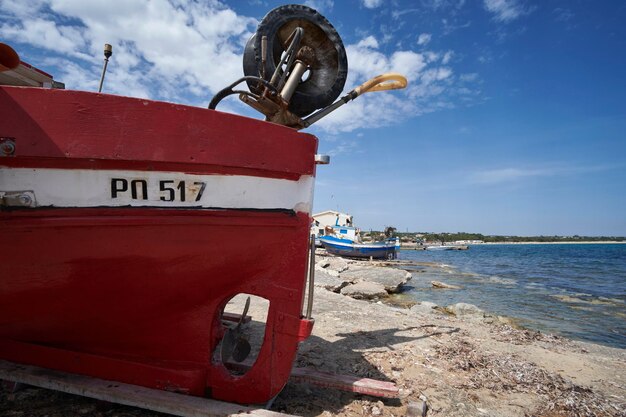 Italy, sicily, mediterranean sea, sampieri (ragusa province); wooden fishing boats ashore