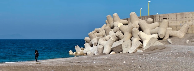 Italy, Sicily, Messina province, concrete tetrapods on the beach near a port under construction