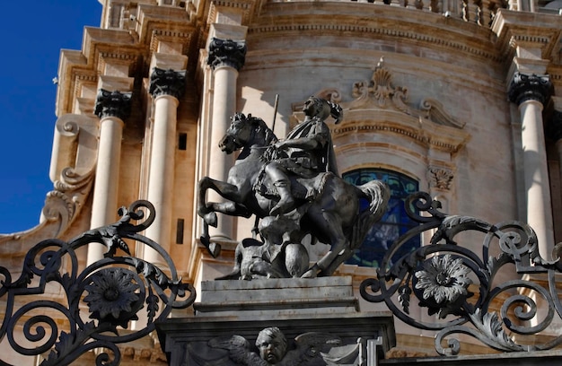 Italy, sicily, ragusa ibla, st. george cathedral, st. george iron statue on the entrance gate