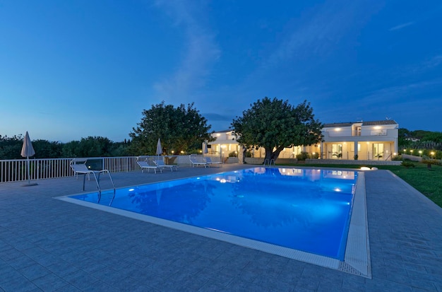 Italy Sicily Ragusa Province countryside house garden and swimming pool at sunset