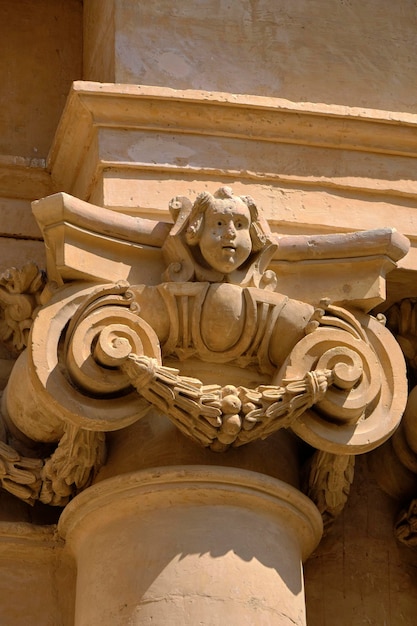 Italy, Sicily, Scicli (Ragusa Province), St. John Cathedral baroque facade (1803 a.C.), column and ornamental statue