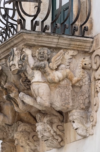 Italy, Sicily, Scicli (Ragusa province), the Unesco Baroque Fava Palace facade, balcony ornamental statues (18th Century a.C.)