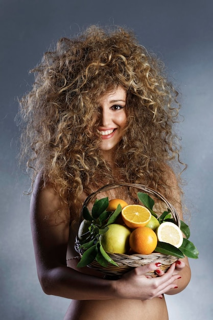 Italy studio portrait of a beautiful girl with a basket full of oranges lemons and grapefruits