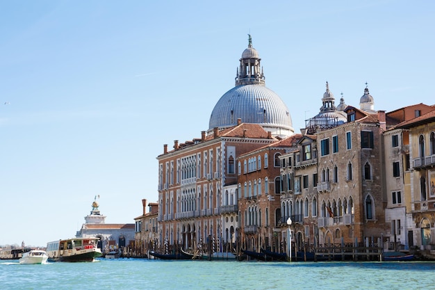 Italy Venice 25 February 2017 A street in Venice with old houses on the water boats and city ferry