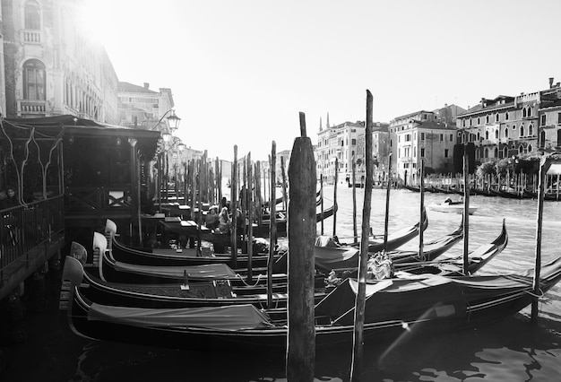 Italy Venice February 25 2017 black and white photo of Venice street with lots of gondolas river and facades of houses