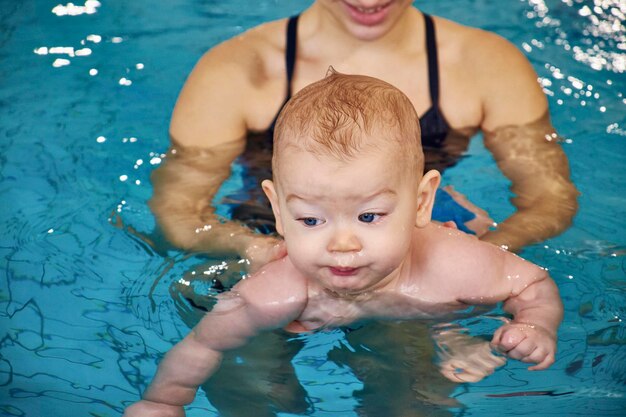 イタリア、プールにいる若い母親と生まれたばかりの男の子