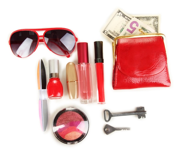 Items contained in the women's handbag isolated on white