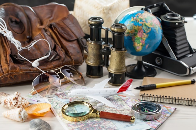 Items used in travel on the background of maps