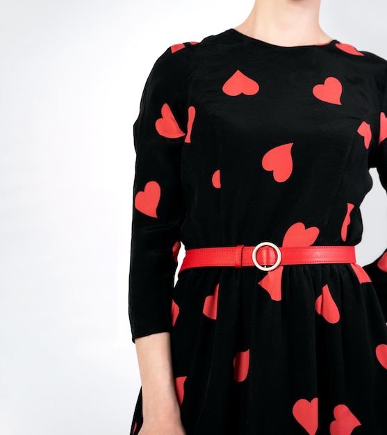 Items of women's clothing dark dress and red strap