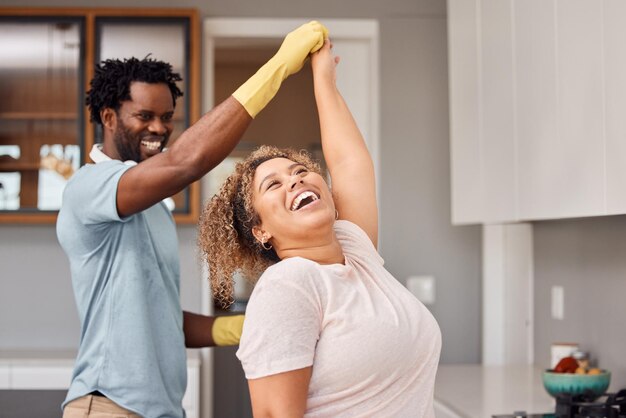 Its always a good time when we do chores together Shot of a young couple dancing while cleaning at home