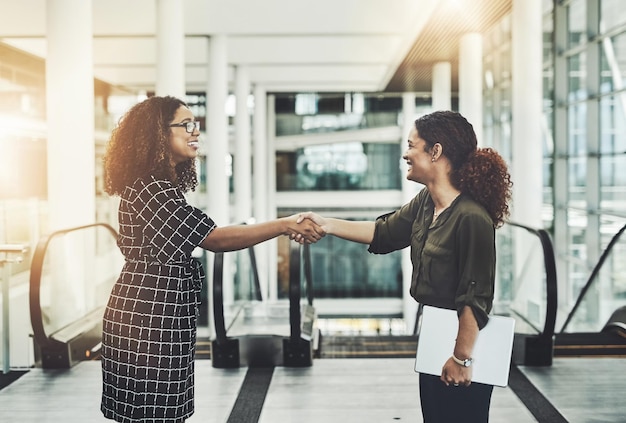 Its been great working with you Shot of two attractive businesswomen shaking hands in the workplace