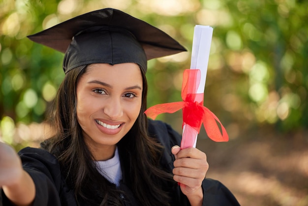 Its a big day for me. Cropped portrait of an attractive young female graduate posing outside with her degree.