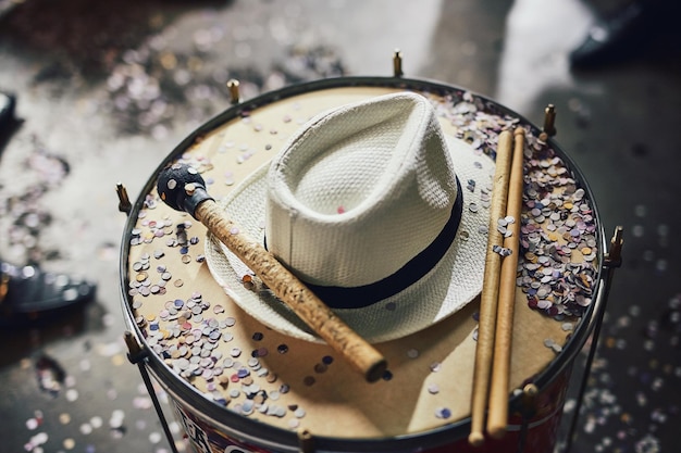 Its carnival time Still life shot of a fedora and confetti on a drumset