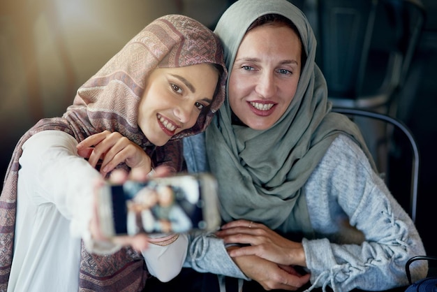 Its not a catch up until you take a selfie Shot of two women taking selfies with a mobile phone in a cafe