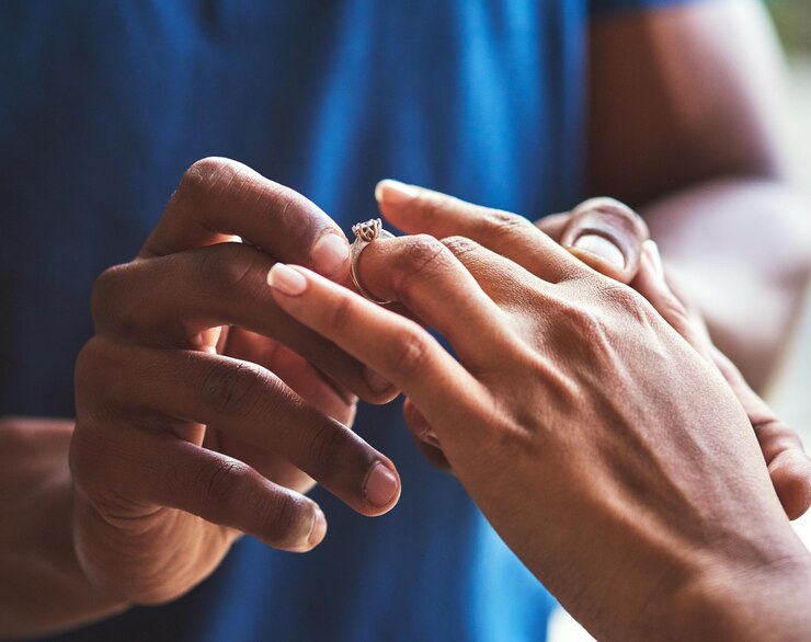 Photo its a celebration of eternal love closeup shot of an unrecognizable man putting an engagement ring onto his fiancees finger