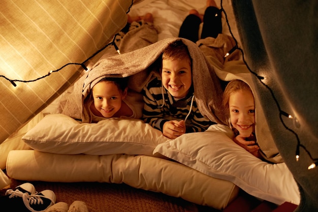 Its going to be a while until we get to sleep Shot of three young children playing in a tent together