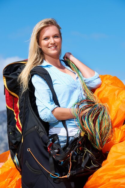 Its a great day to fly Shot of a young woman getting ready to go paragliding