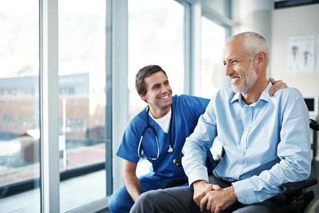 Photo its my job to keep you happy and well shot of a male nurse caring for a senior patient